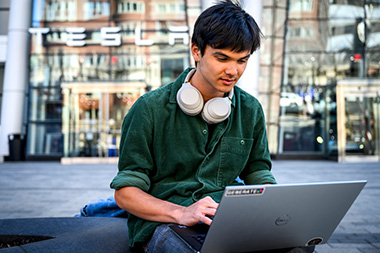 Electrical and computer engineering undergraduate student Kaden Du sitting looking at his computer. 