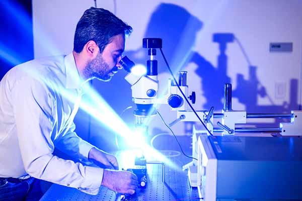 professor looking into microscope